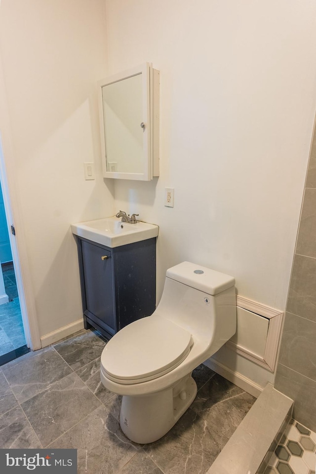 bathroom featuring vanity and toilet