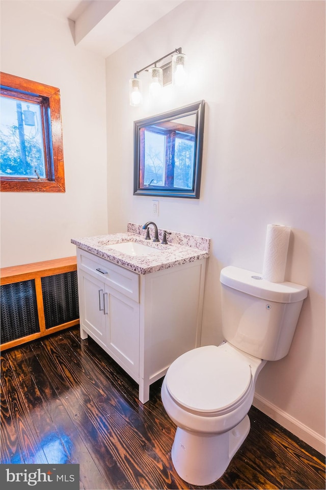 bathroom featuring hardwood / wood-style flooring, vanity, and toilet