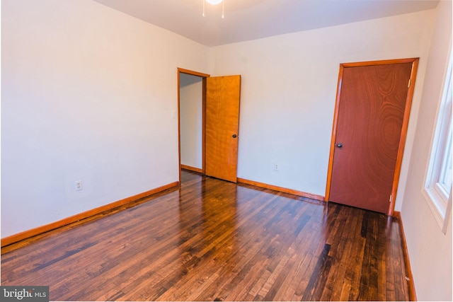 unfurnished room featuring dark hardwood / wood-style flooring