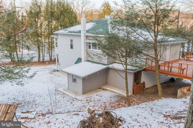 view of snowy exterior featuring a wooden deck