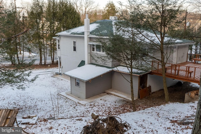 view of snowy exterior featuring a deck