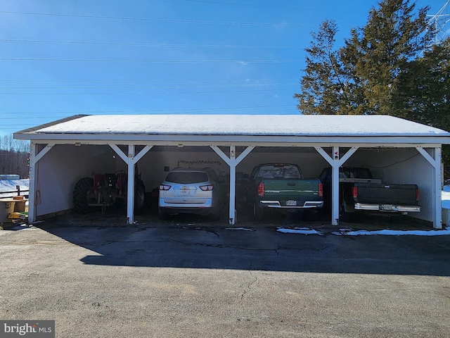 view of parking / parking lot featuring a carport