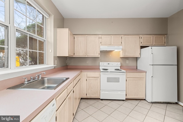 kitchen featuring sink, white appliances, light tile patterned floors, and light brown cabinets