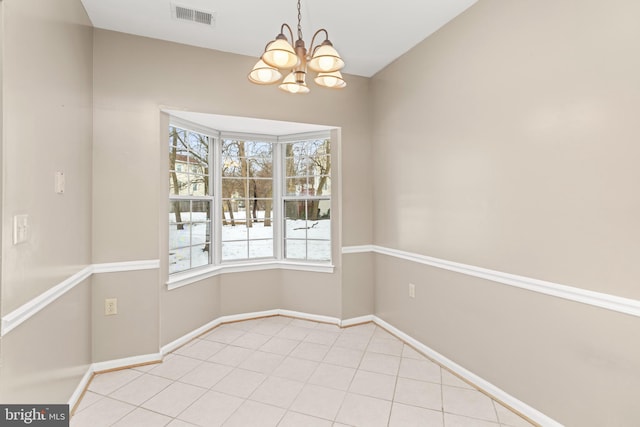 unfurnished dining area featuring light tile patterned flooring and an inviting chandelier