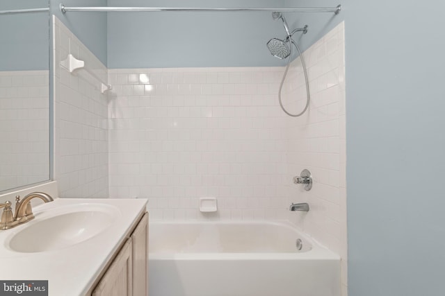 bathroom with tiled shower / bath and vanity