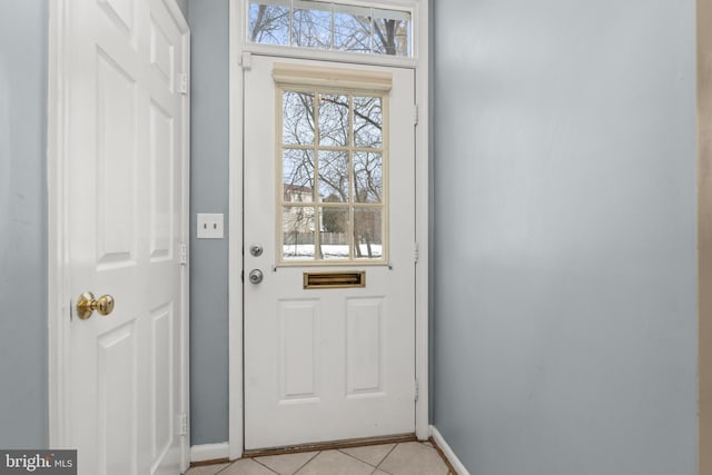 doorway to outside featuring light tile patterned flooring