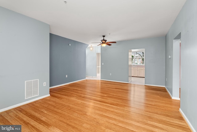 unfurnished living room featuring ceiling fan and light hardwood / wood-style flooring