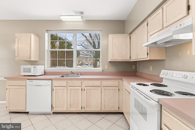 kitchen featuring light brown cabinetry, sink, white appliances, and light tile patterned flooring