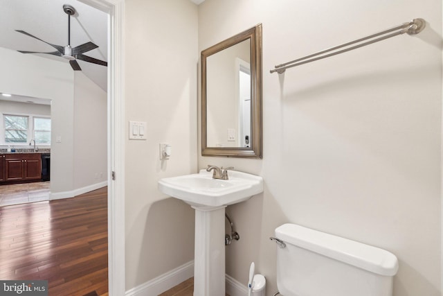 bathroom with hardwood / wood-style flooring, sink, ceiling fan, and toilet