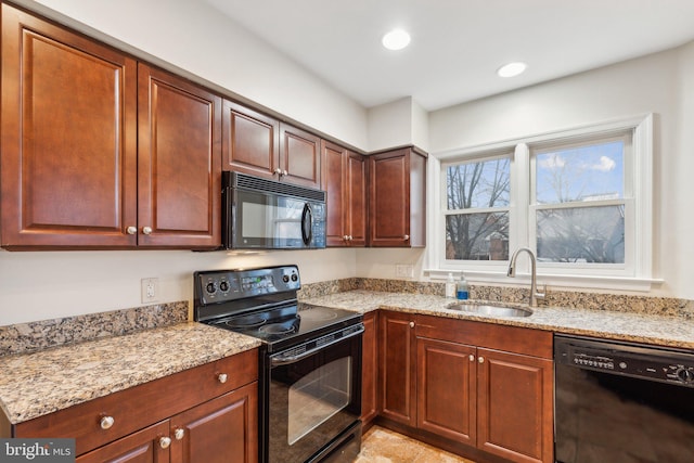 kitchen featuring sink, black appliances, and light stone countertops