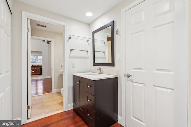 bathroom with vanity, hardwood / wood-style floors, and toilet