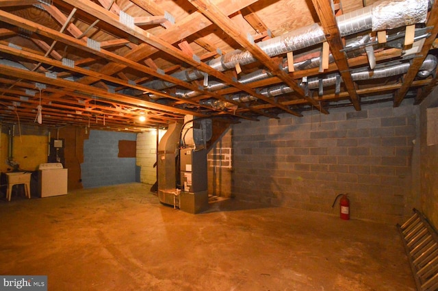 basement with washer / clothes dryer and heating unit