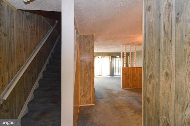 stairway with wood walls