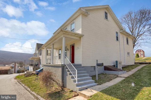 view of property exterior with covered porch