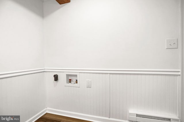 washroom featuring a baseboard radiator, dark hardwood / wood-style floors, and washer hookup