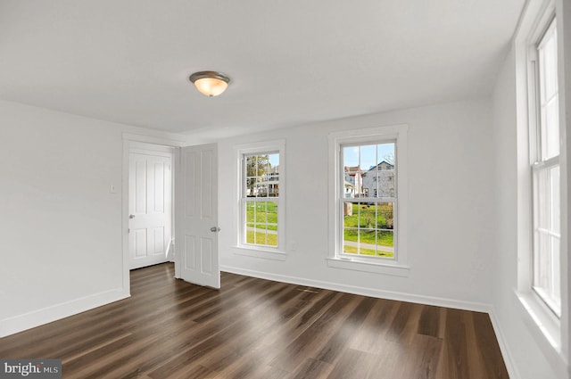 spare room with dark hardwood / wood-style floors