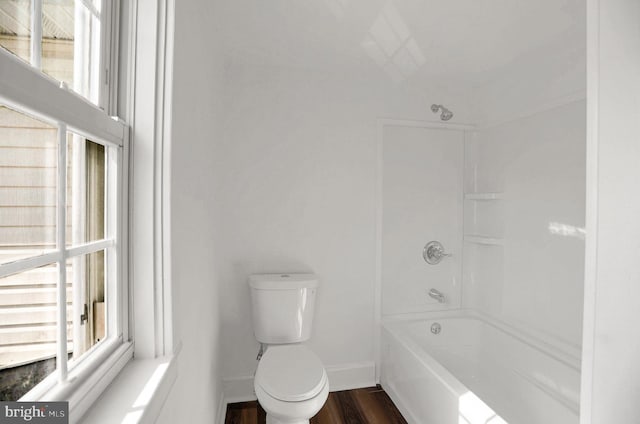 bathroom featuring shower / bathing tub combination, hardwood / wood-style floors, and toilet