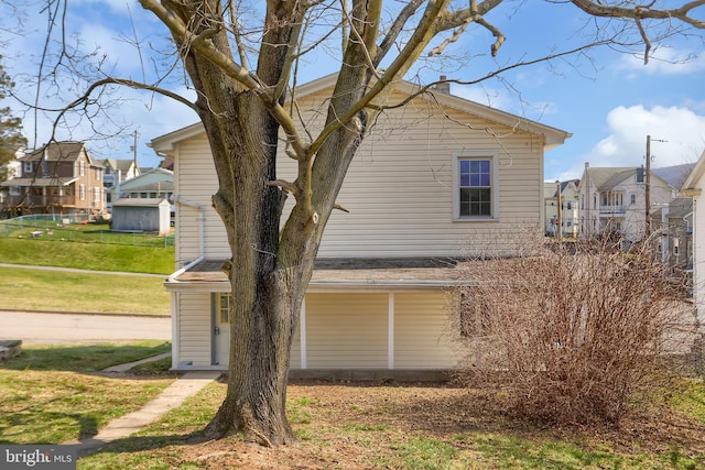 view of property exterior with a lawn