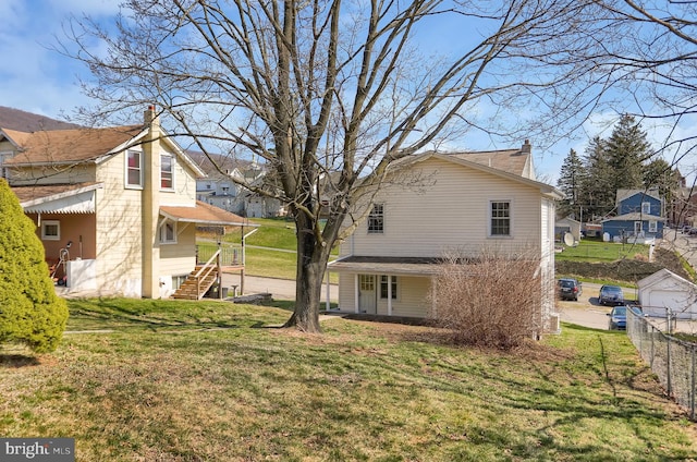 rear view of house with a yard