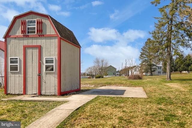 view of outdoor structure featuring a lawn