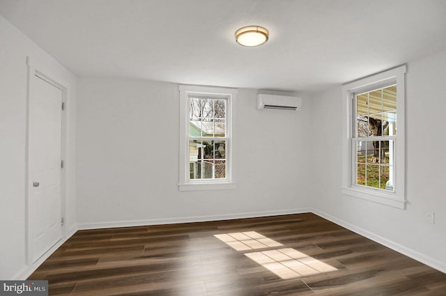 unfurnished room featuring a wall mounted air conditioner and dark wood-type flooring