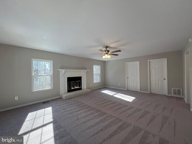 unfurnished living room featuring carpet and ceiling fan