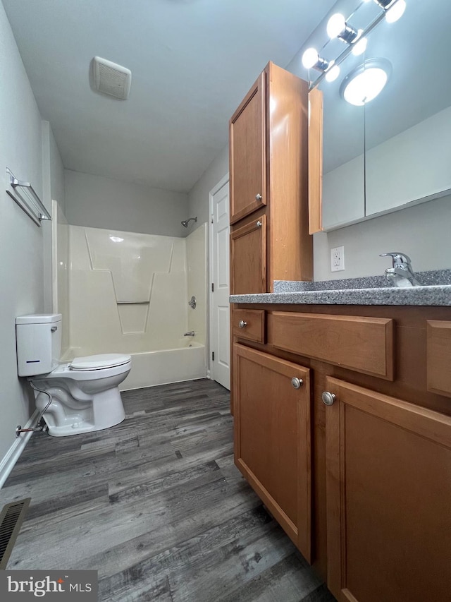 full bathroom with toilet, vanity, shower / bathtub combination, and hardwood / wood-style flooring