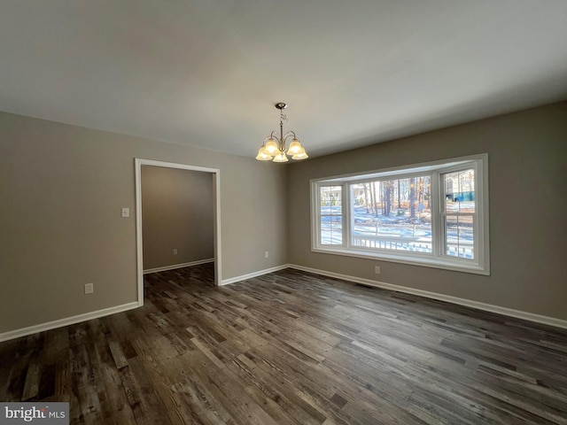 unfurnished dining area featuring dark hardwood / wood-style flooring and a notable chandelier