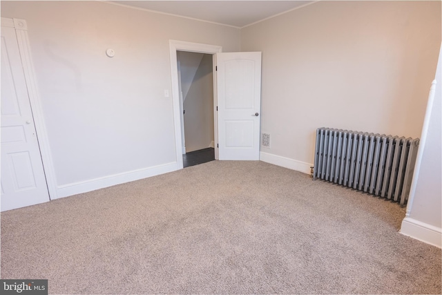 unfurnished room with carpet floors and radiator