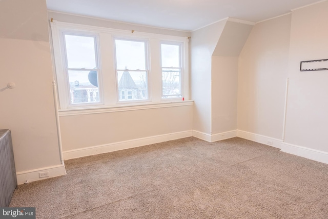 bonus room featuring carpet and radiator heating unit