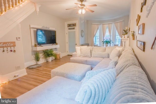 living room featuring ceiling fan and hardwood / wood-style flooring