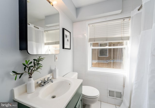 bathroom featuring tile walls, toilet, and vanity