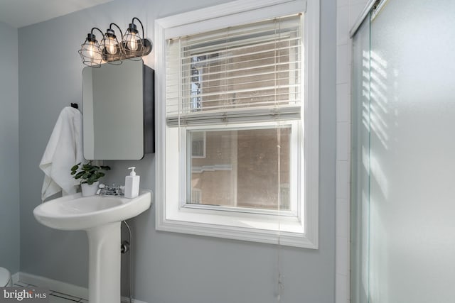 bathroom featuring a chandelier and tile patterned flooring