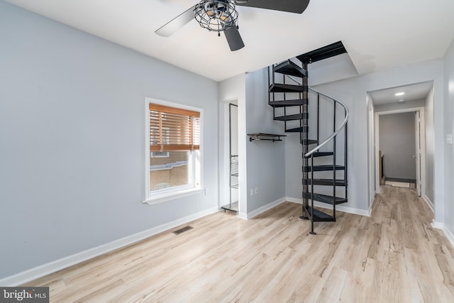 stairs with ceiling fan and wood-type flooring