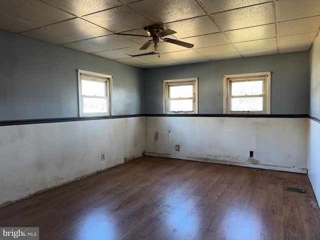 spare room featuring hardwood / wood-style flooring, a paneled ceiling, and ceiling fan