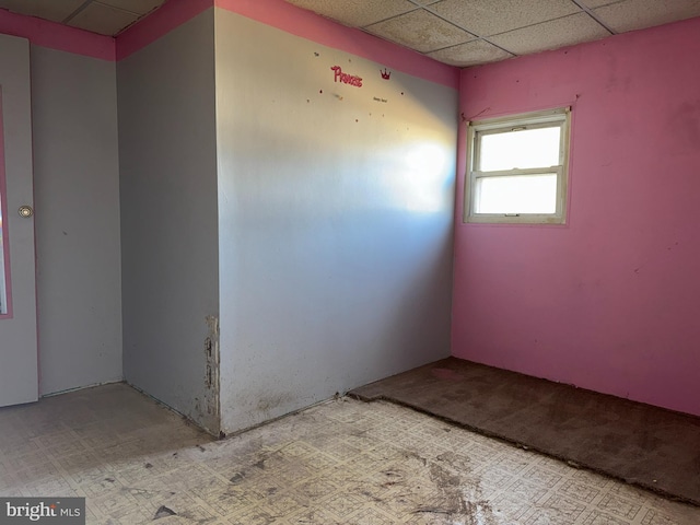 unfurnished room featuring a paneled ceiling