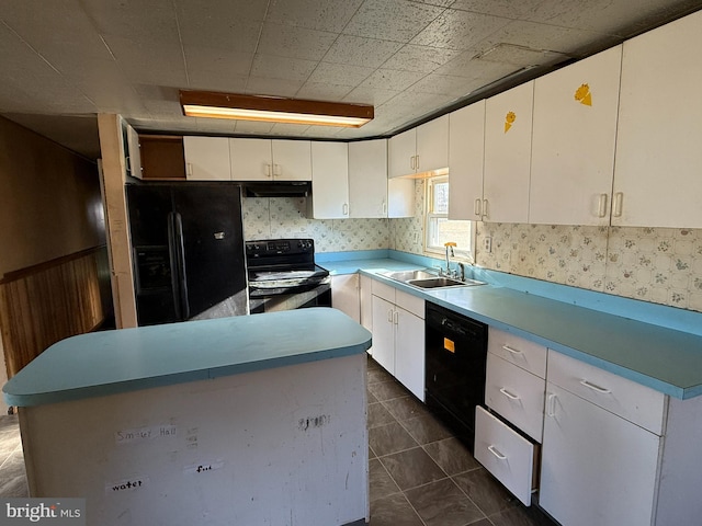 kitchen featuring white cabinetry, sink, a kitchen island, and black appliances