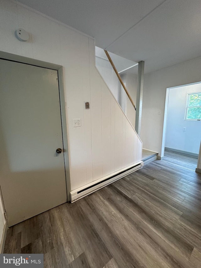 interior space featuring a baseboard heating unit and hardwood / wood-style floors