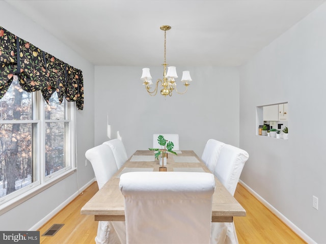 dining room featuring an inviting chandelier and light hardwood / wood-style floors