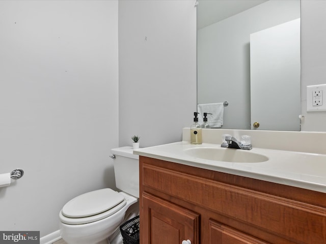 bathroom with toilet and vanity