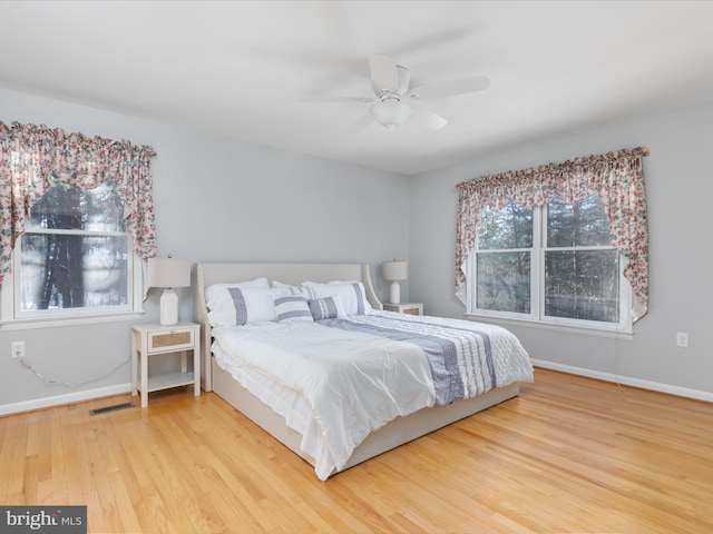 bedroom with ceiling fan and hardwood / wood-style flooring