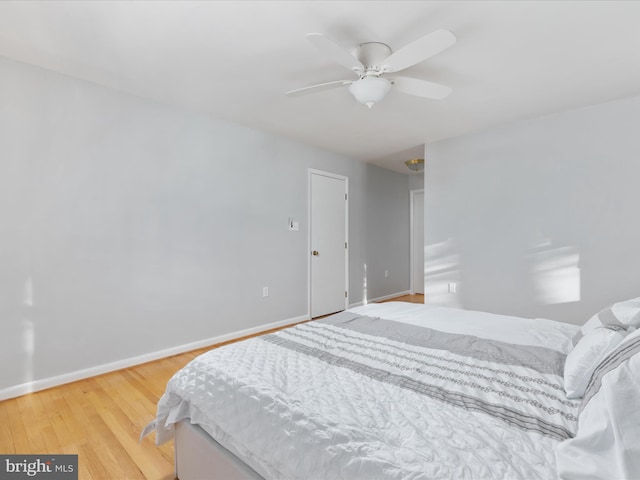 bedroom with light wood-type flooring and ceiling fan