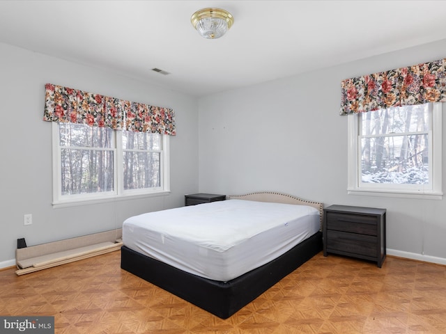 bedroom with light parquet floors