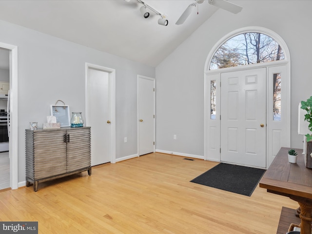 entrance foyer featuring lofted ceiling, wood-type flooring, and ceiling fan