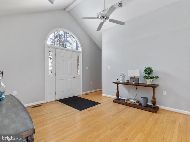 foyer entrance with ceiling fan, hardwood / wood-style floors, and lofted ceiling