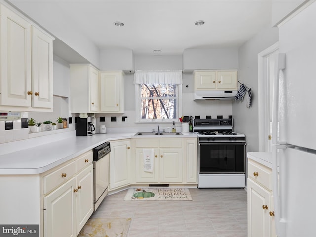 kitchen featuring decorative backsplash, sink, white appliances, light tile patterned flooring, and white cabinets