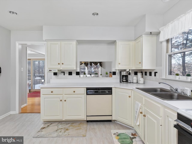 kitchen featuring white cabinetry, white dishwasher, range, and sink