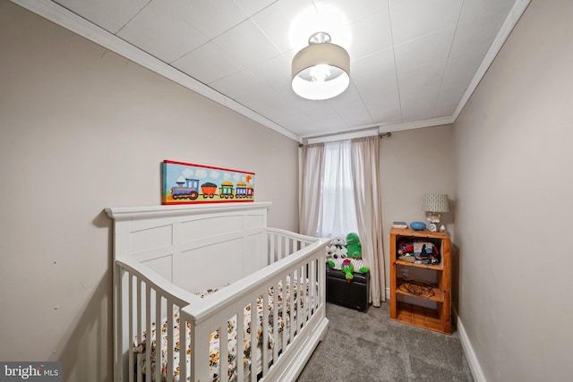 bedroom featuring crown molding, a crib, and carpet flooring