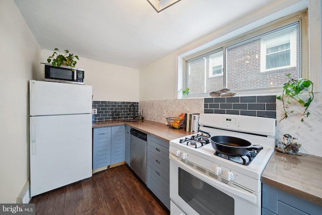 kitchen featuring decorative backsplash, dark wood-type flooring, sink, and stainless steel appliances