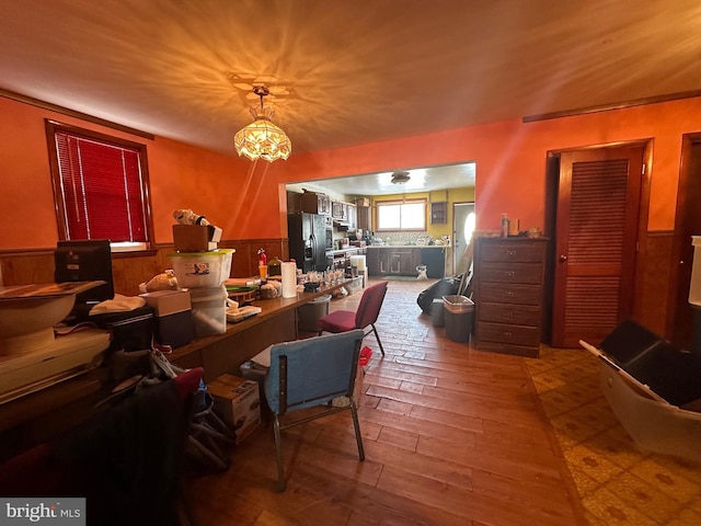 dining area featuring wood walls and hardwood / wood-style floors